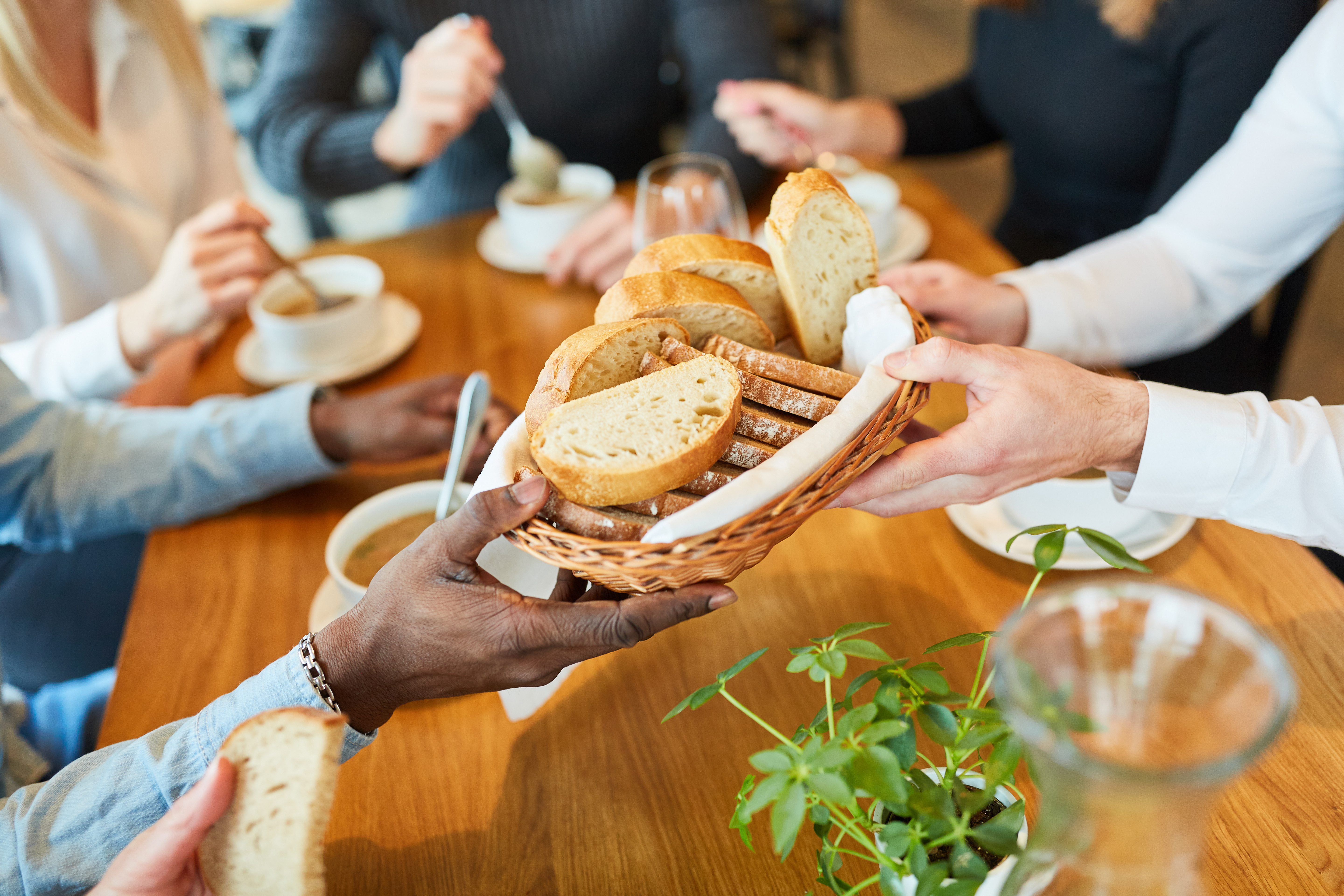 Our Mission - Community sharing fresh baked bread around a table