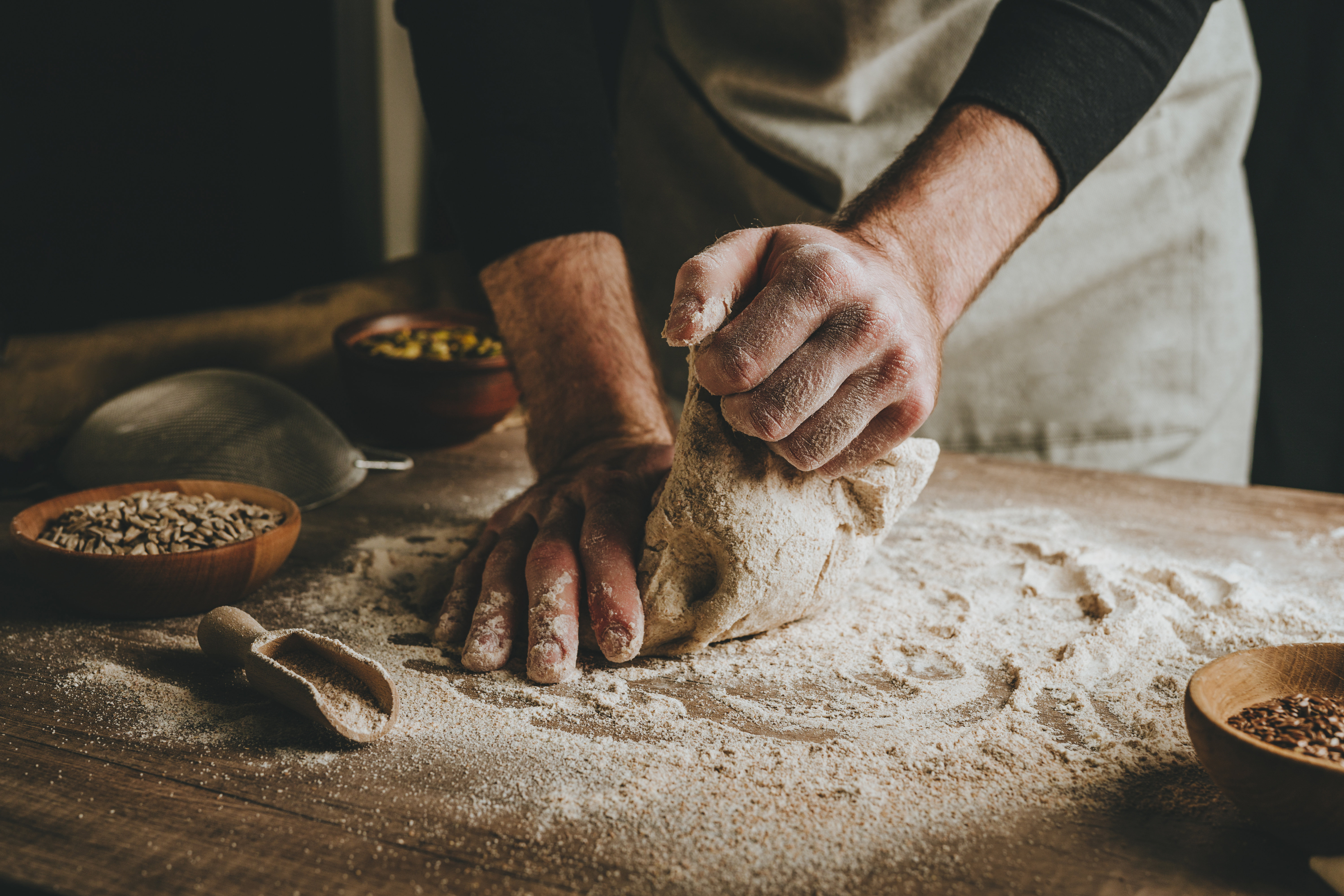 Our Story - Traditional bread making with skilled hands kneading dough